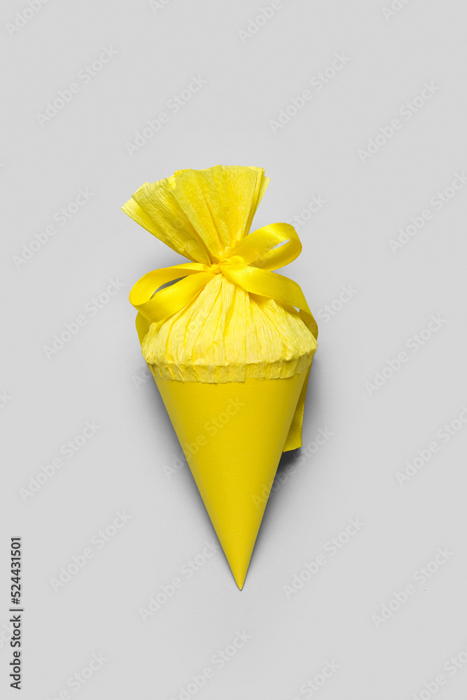 Yellow school cone on grey background