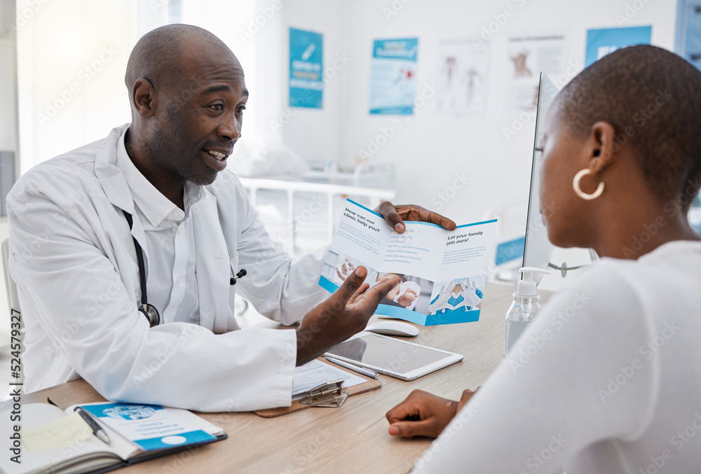 A doctor giving patient hospital information at a clinic and explaining medical benefits to a woman 