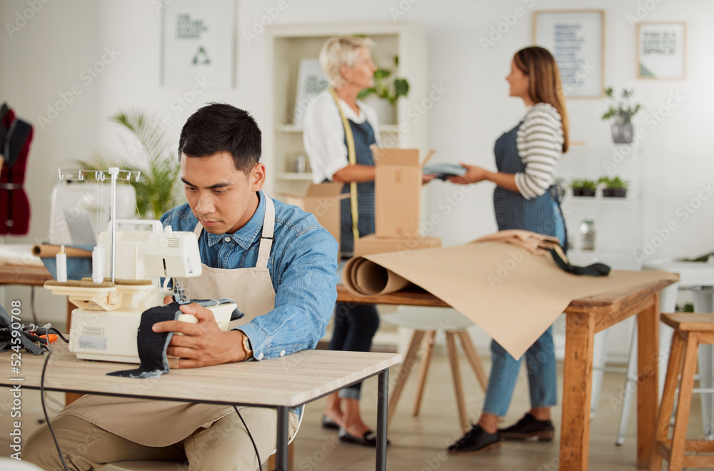 Tailor, seamstress and creative designer working on a sewing machine in a design studio or workshop.