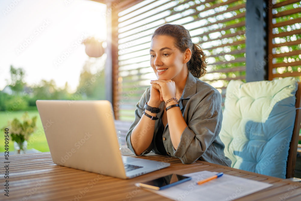 woman is working sitting on the patio