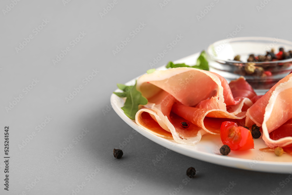 Plate of delicious jamon on light background, closeup