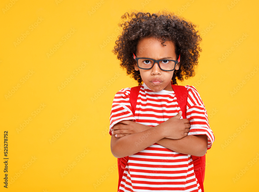 Funny ethnic schoolboy with  making face