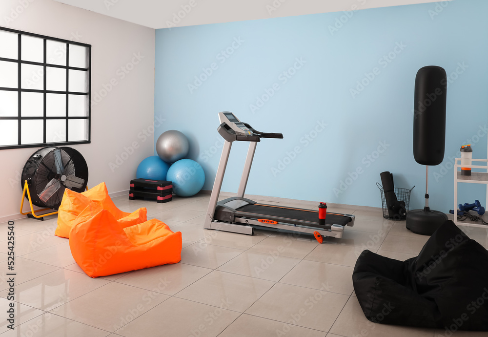 Interior of gym with treadmill and sport equipment