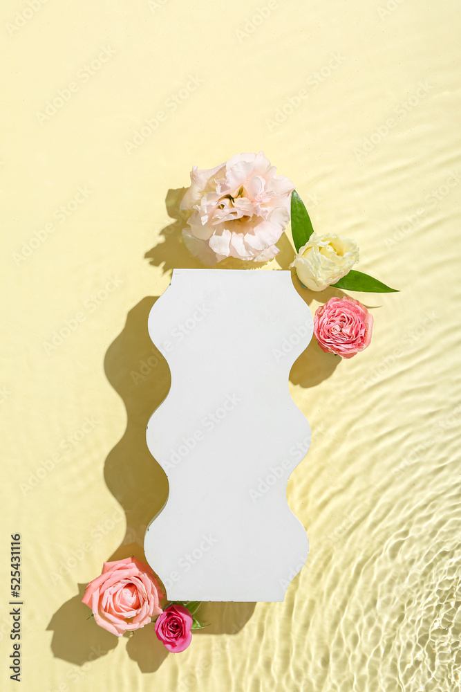 Decorative stand and beautiful flowers in water against yellow background