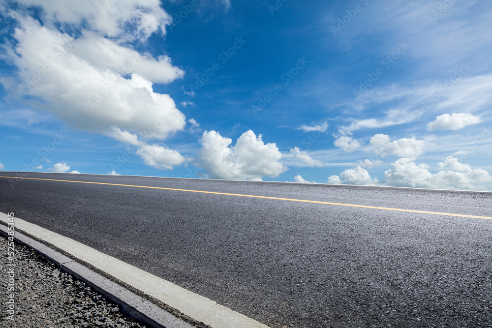 Asphalt road and sky clouds background