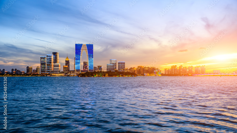 City skyline and modern buildings in Suzhou at sunset, China.