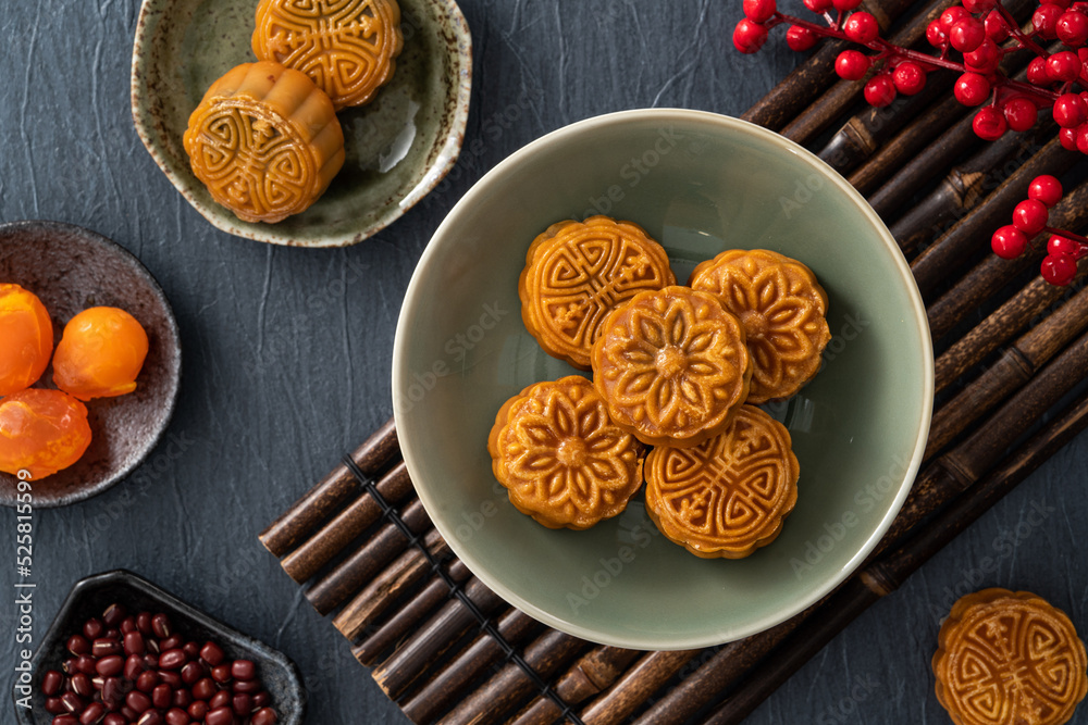 Delicious Cantonese moon cake for Mid-Autumn Festival food mooncake on blue table background.