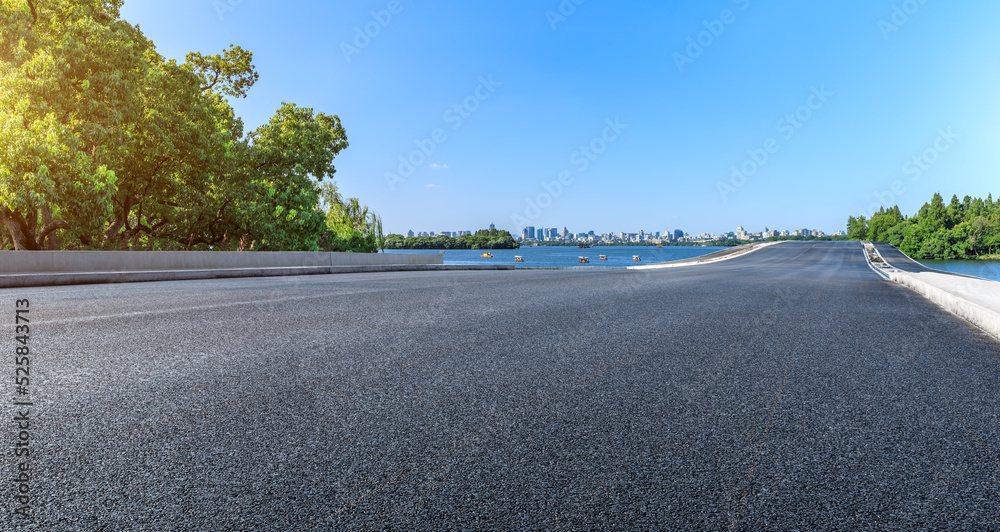 Empty asphalt road and city skyline with modern buildings scenery in Hangzhou, China.