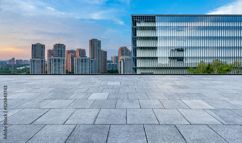 Empty floor and modern city skyline with building scenery at sunset