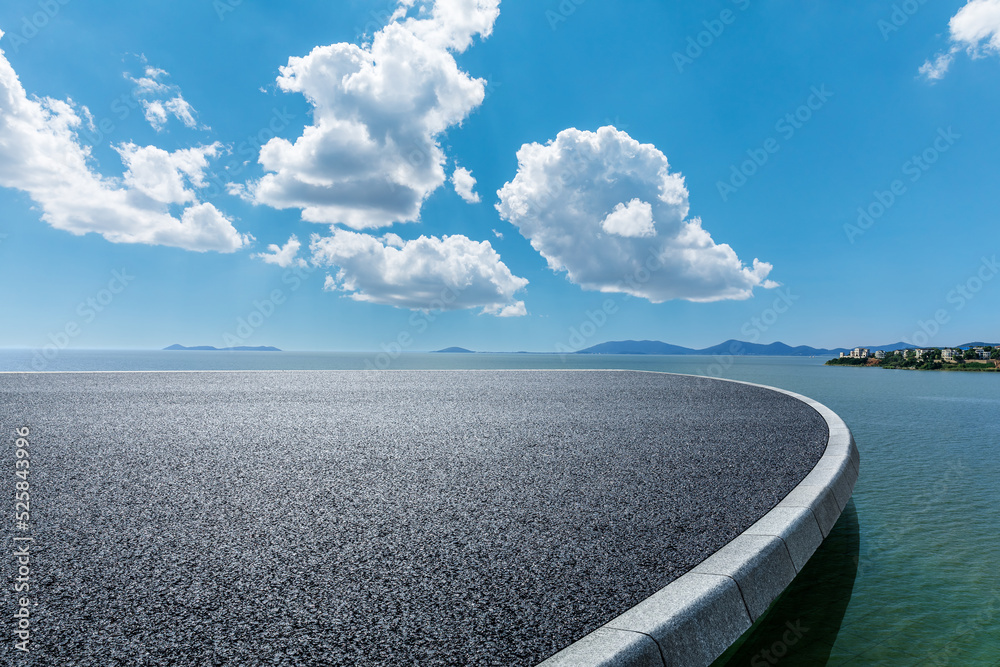 Asphalt road and river with mountain nature landscape under blue sky