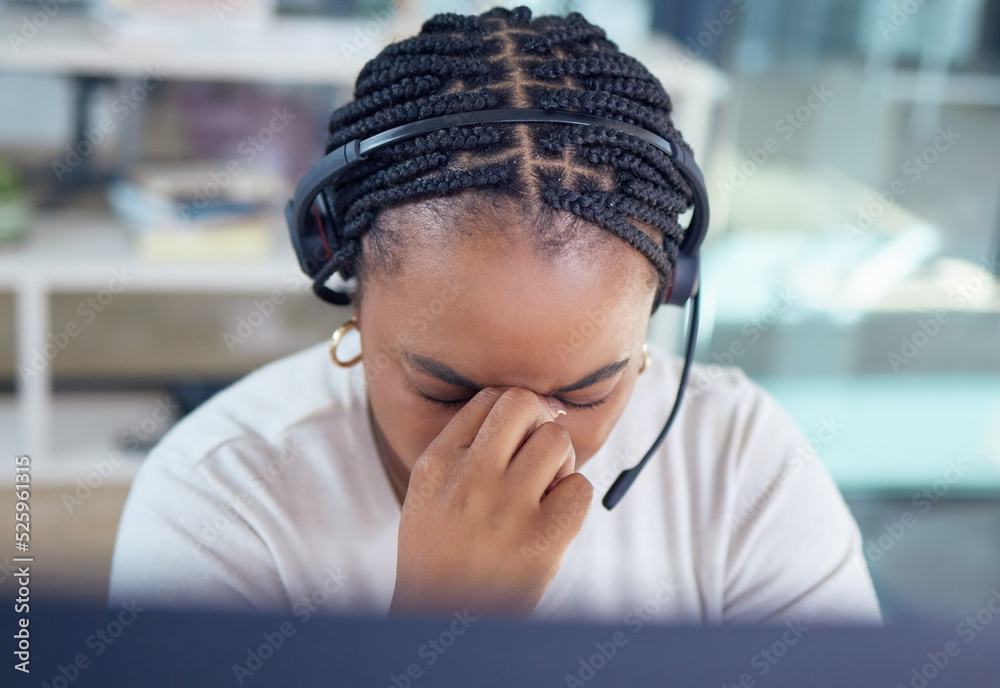 Stress, burnout and sad call center agent with a headache and office overworked sitting in an office