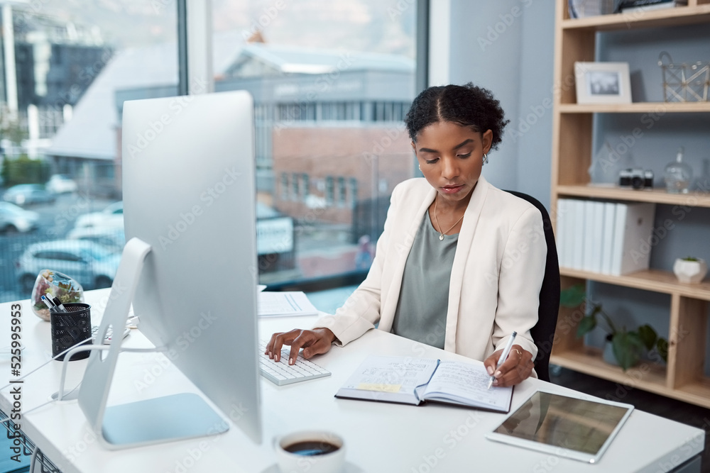 Finance manager writing notes, typing on a computer keyboard and planning to check financial data in