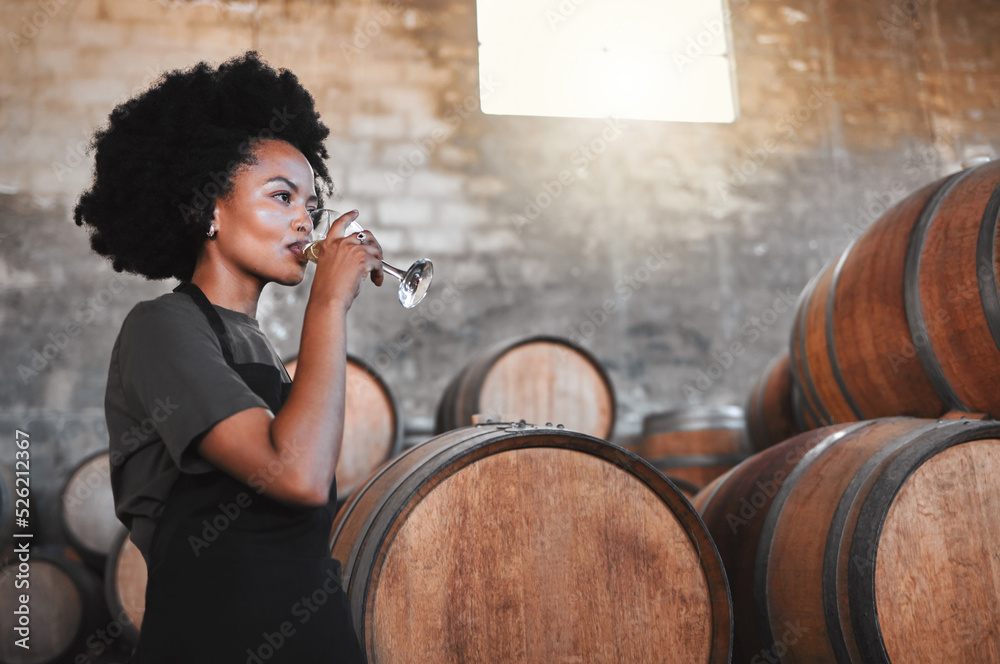 Wine, drink and cellar woman tasting a glass from their manufacturing or farming distillery plant as