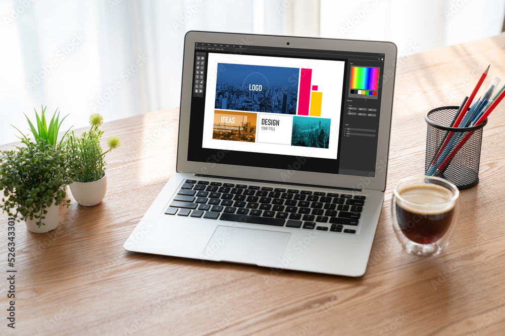 Graphic designer software for modern design of web page and commercial ads showing on the computer s