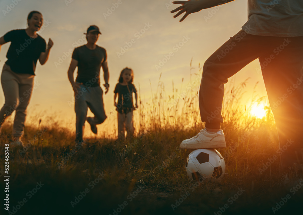 Happy family playing soccer