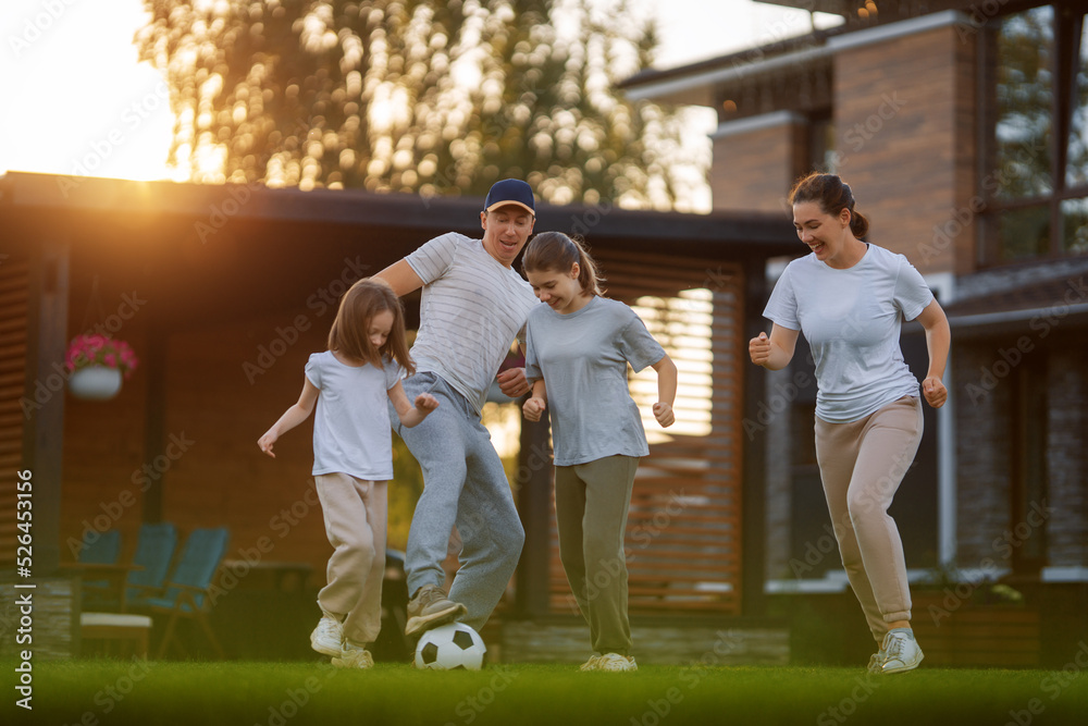 Happy family playing soccer