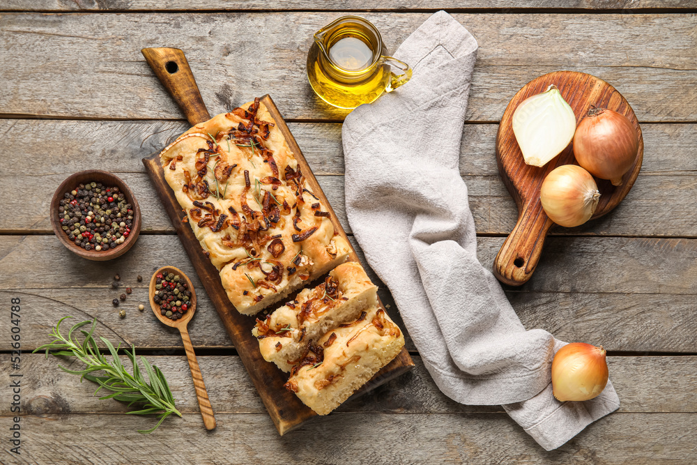 Composition with tasty Italian focaccia and ingredients on wooden background