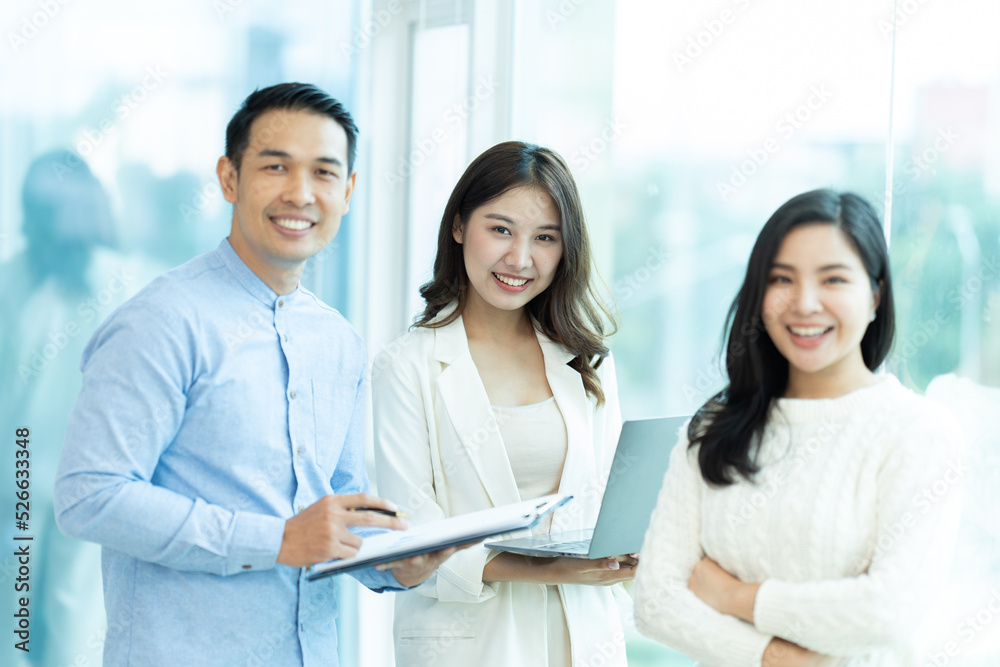 Business people showing team work while working in board room in office interior. People helping one