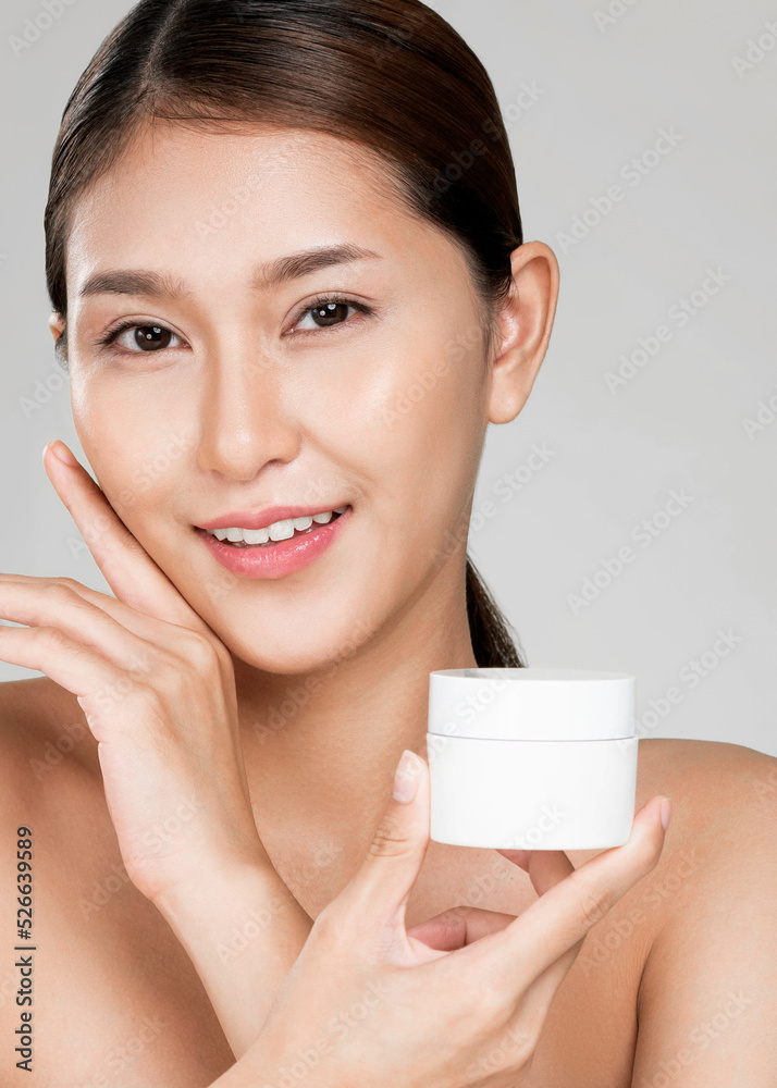 Closeup ardent woman smiling holding mockup product for advertising text place, light grey backgroun