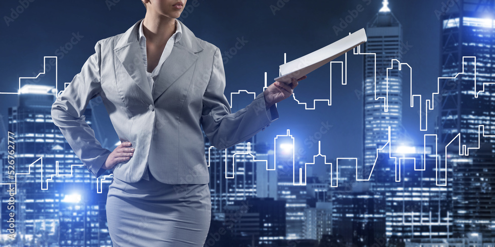 Woman architect or engineer presenting construction concept and holding documents in hand