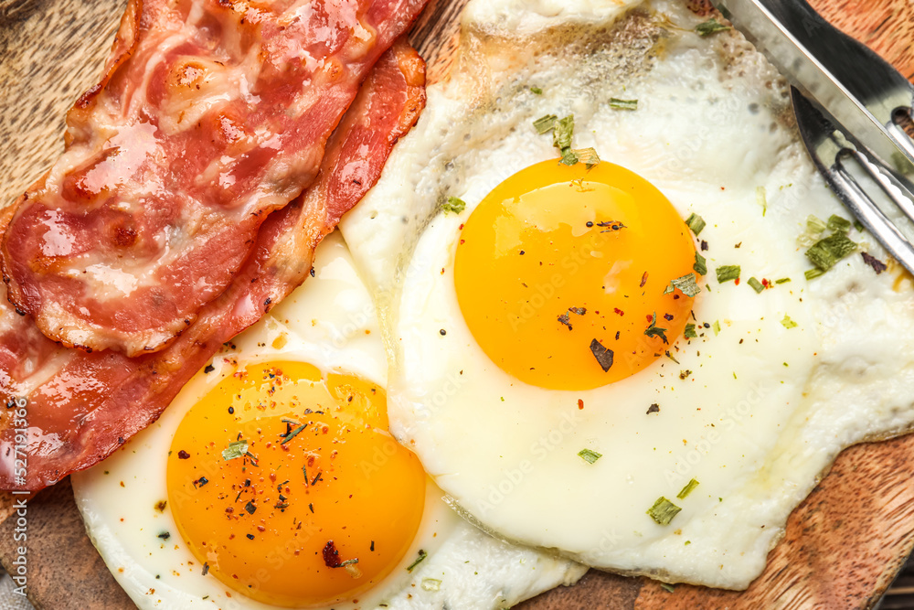 Plate of tasty fried eggs and bacon, closeup