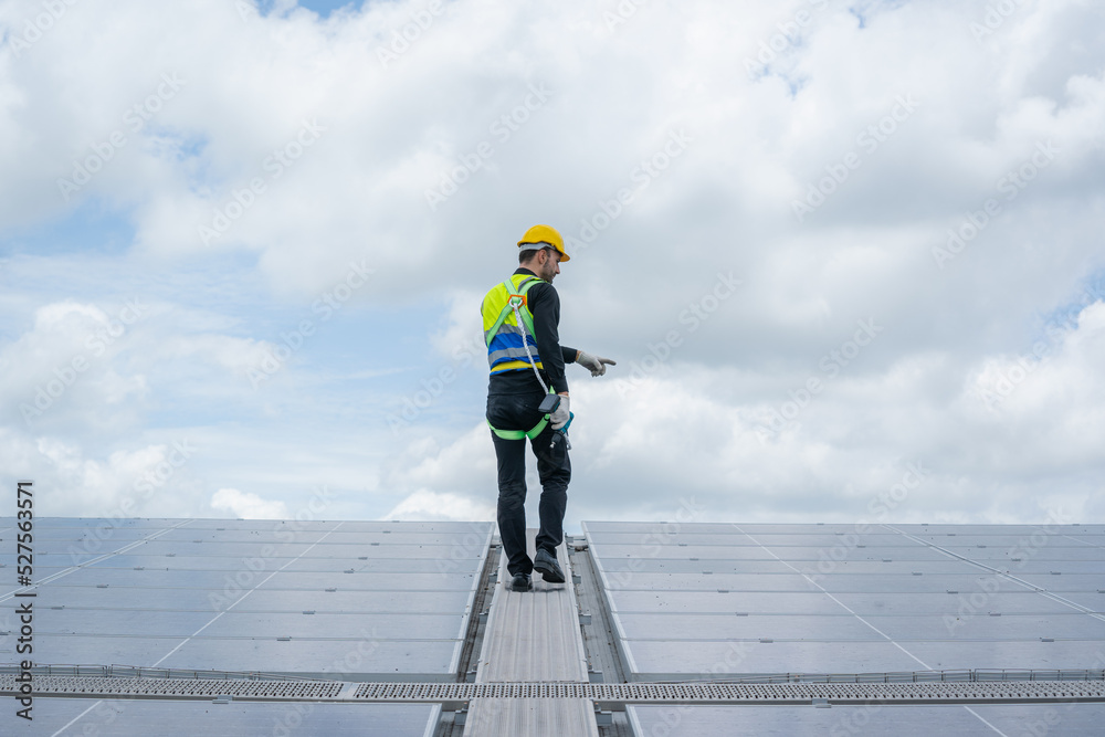 Engineer man or worker checking the operation of the system solar panels or solar cells on roof,Rene