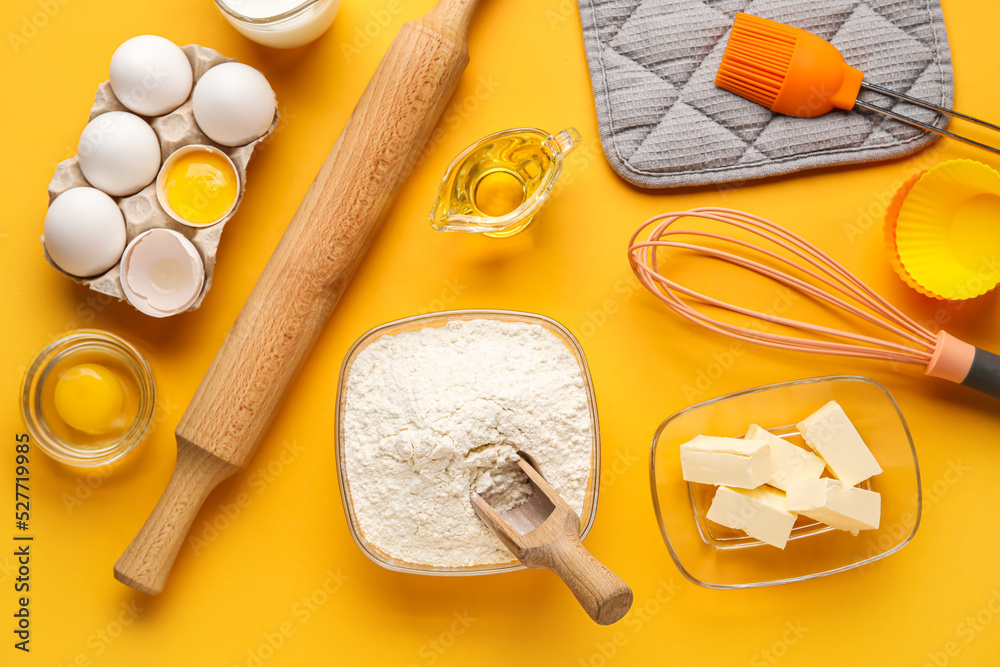 Set of utensils and ingredients for baking on color background