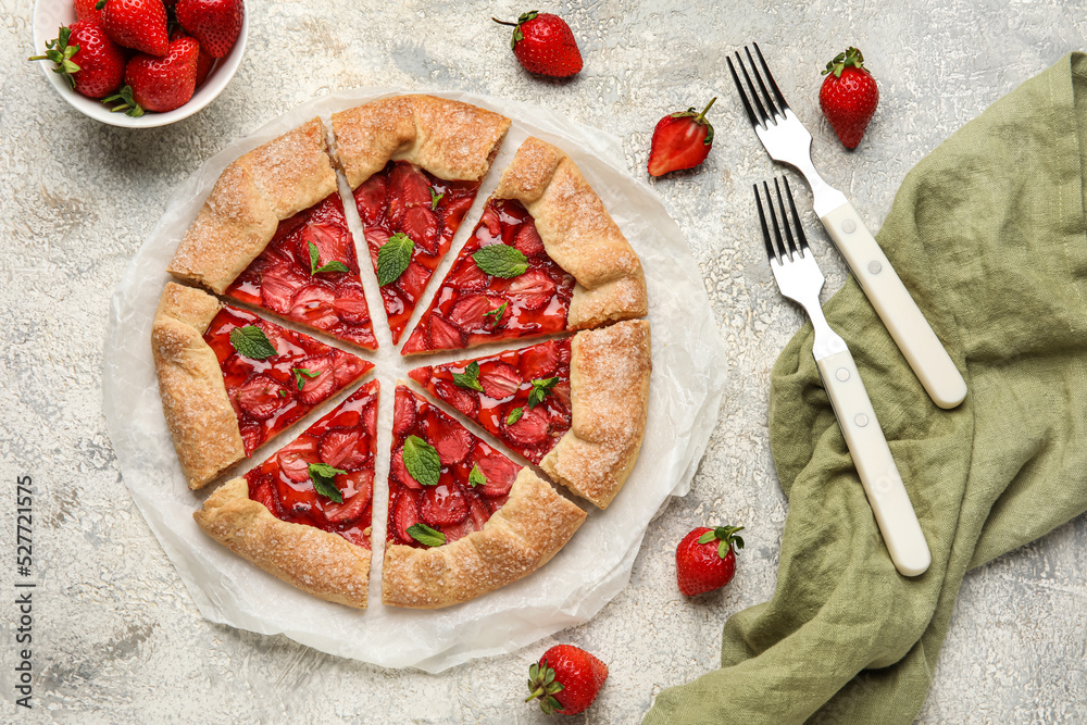 Fresh strawberry galette, fresh berries and forks on light background