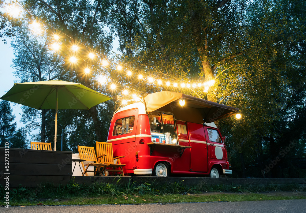 Empty small Street Food Track with an illuminations standing in the deserted night park. Near food t