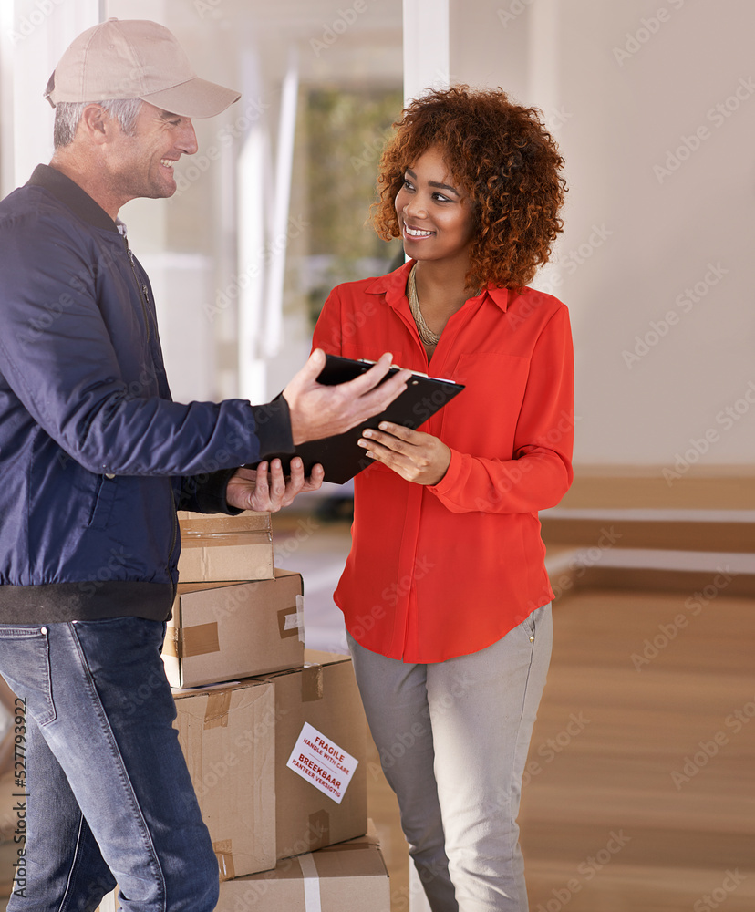 Service with a smile. Shot of a courier making a delivery to a smiling customer.