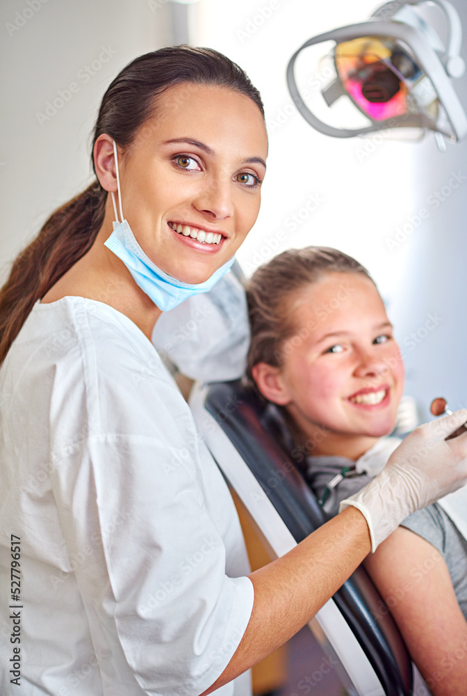 Always professional. Portrait of an attractive female dentist and her child patient.