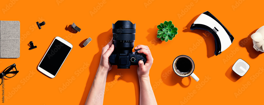 Person holding a SLR camera from above