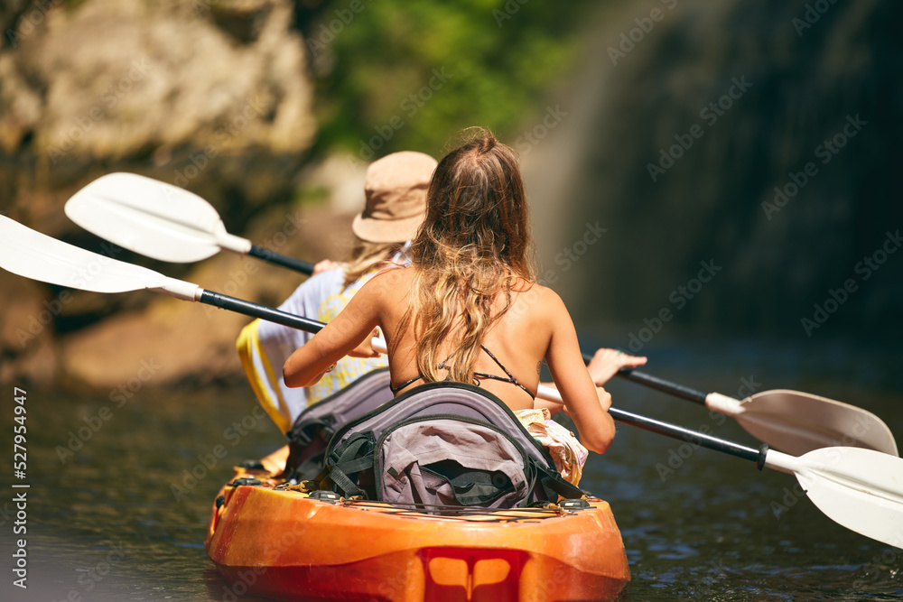 女性朋友在暑假或旅行时在河或湖上划皮划艇或船。游客