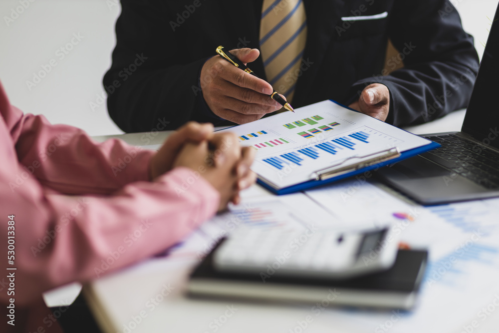 Businessmen meeting to discuss company sales report charts and analyze market strategies. Financial 