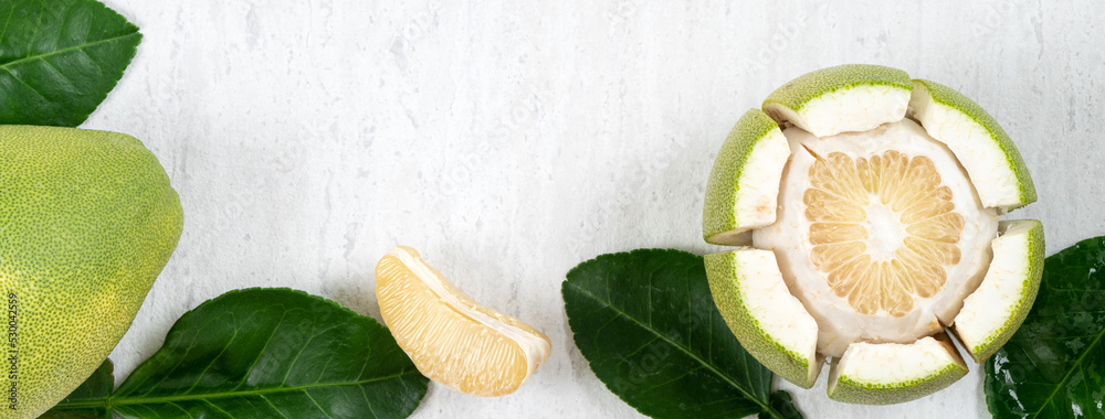 Fresh pomelo fruit on white table background.