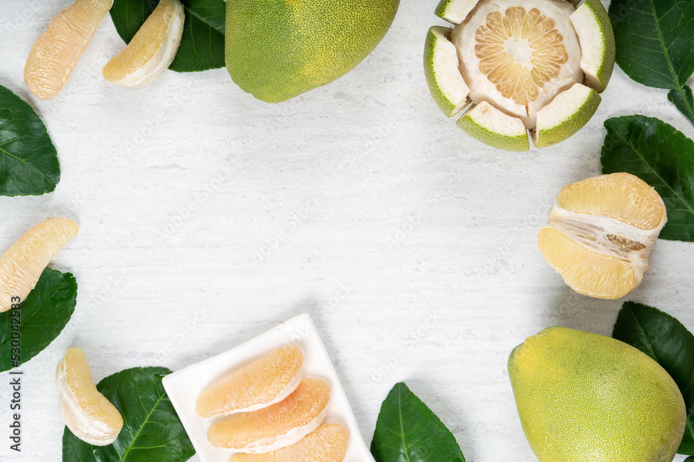 Fresh pomelo fruit on white table background.