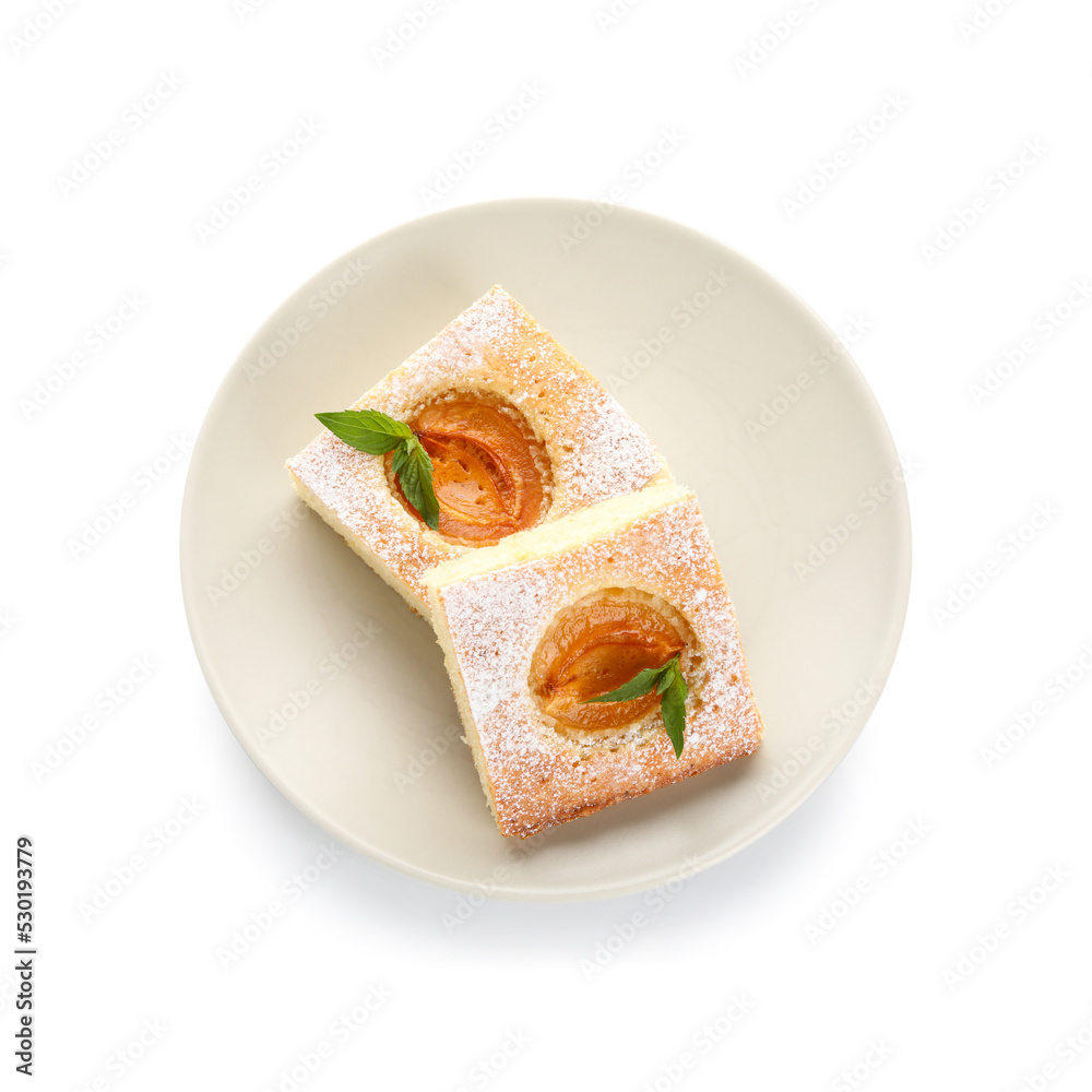 Plate with pieces of tasty apricot pie on white background