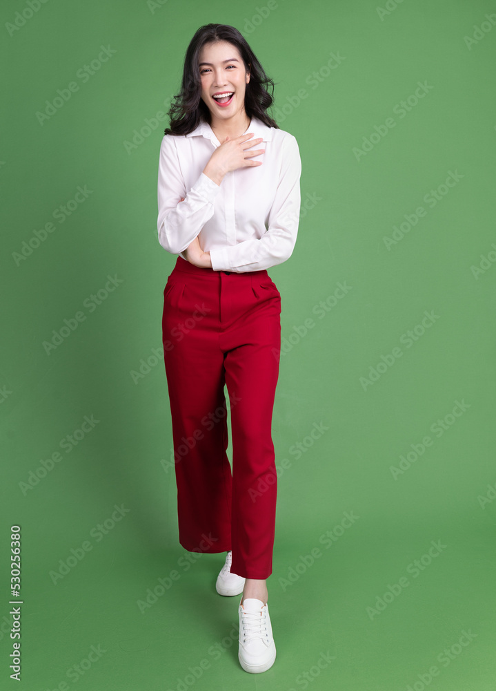 Full length photo of young Asian woman on background