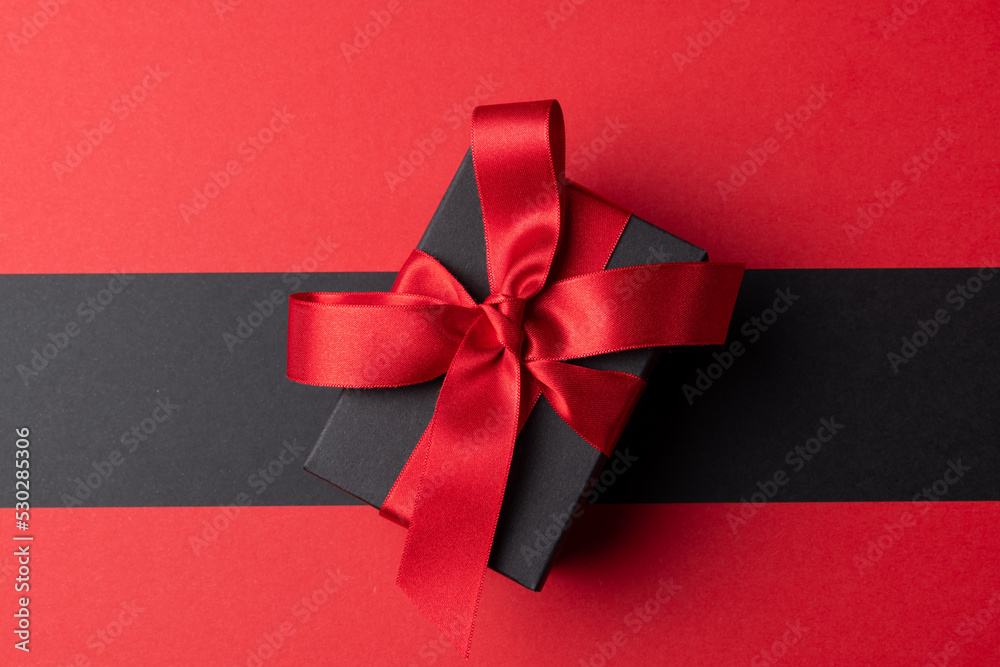 Composition of present with pink ribbon on gray and pink background