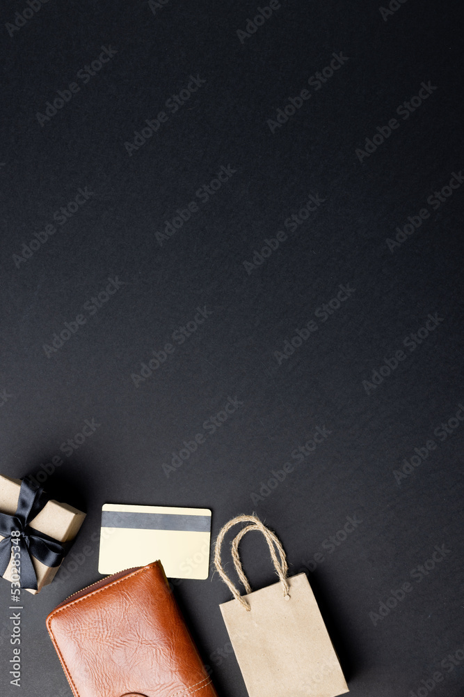 Composition of bag, wallet, present and credit card with copy space on gray background