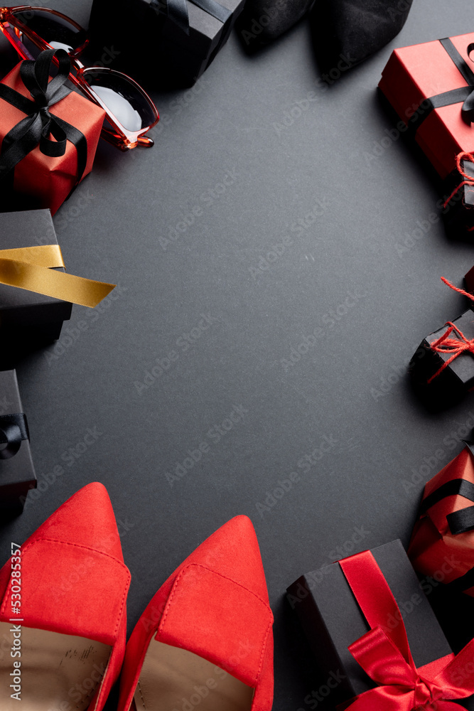 Composition of shoes and presents with copy space on gray background