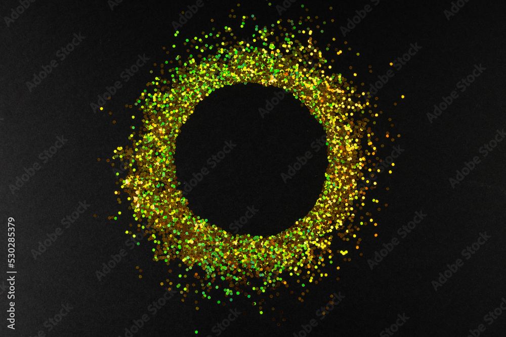 Composition of circle of gold spots on gray background