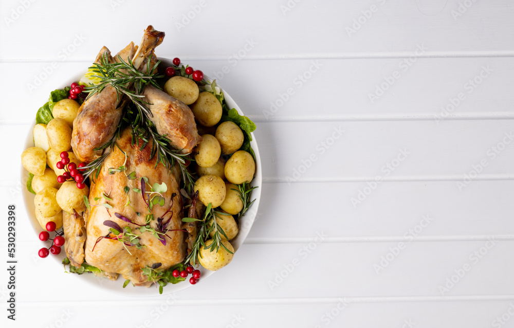 Overhead view of thanksgiving roast turkey with potatoes and copy space on wood