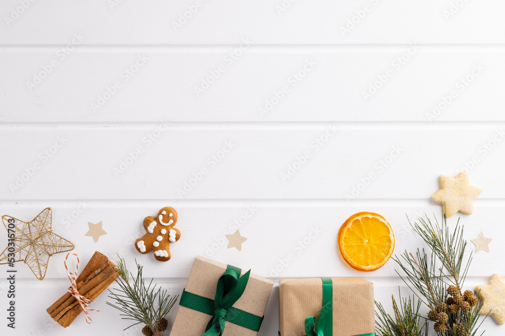 Image of christmas decoration with gingerbread man and copy space on white background