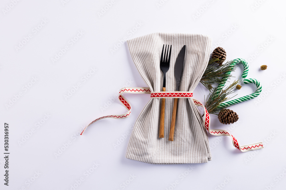 Image of christmas place setting with cutlery and copy space on white background