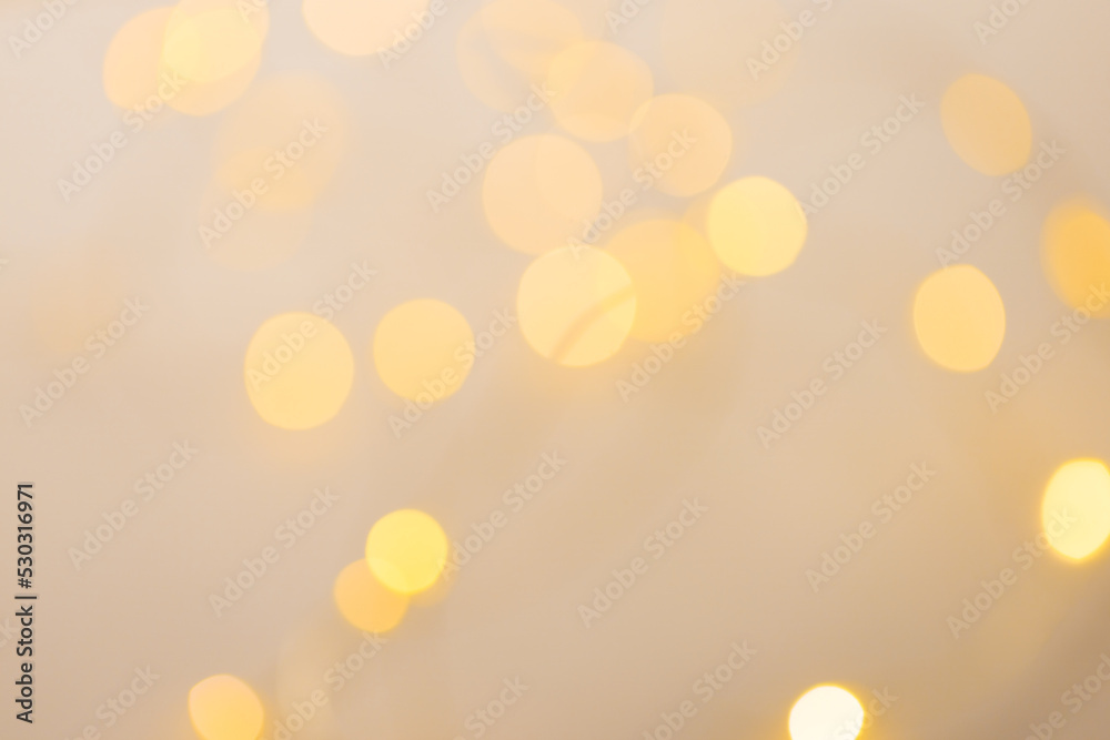 Image of out of focus christmas fairy lights and copy space on cream background