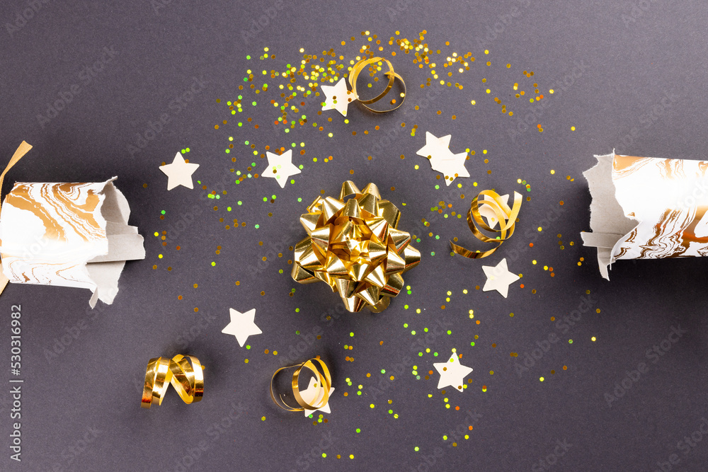 Image of christmas cracker with christmas decoration on grey background