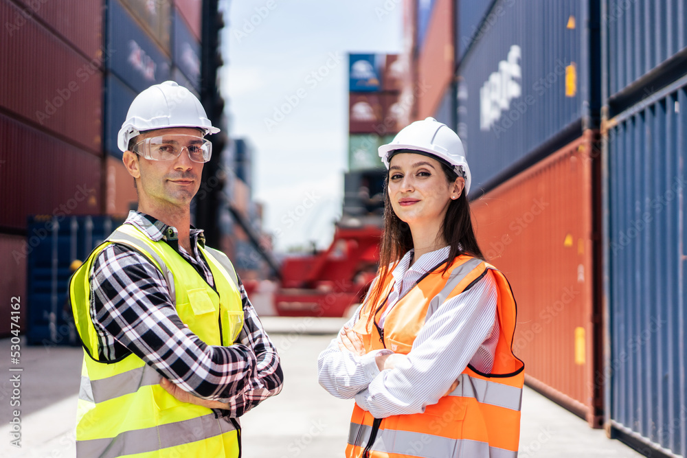 Portrait of Caucasian businessman and woman work in container terminal