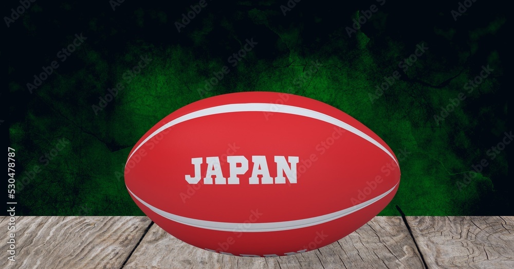 Composition of rugby ball decorated with text japan on black background