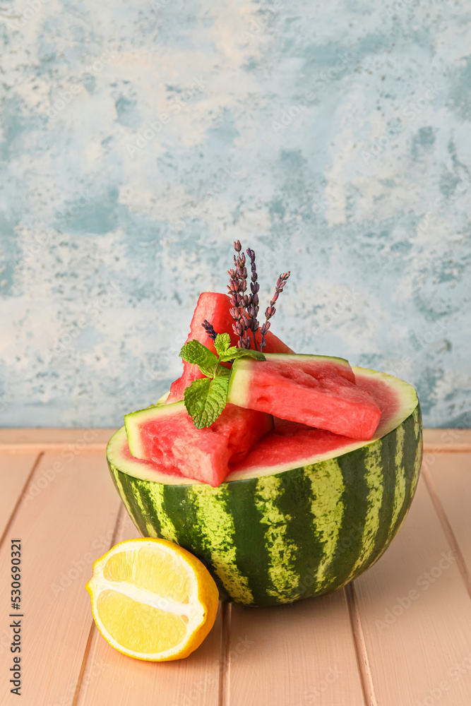 Composition with juicy watermelon on color wooden table